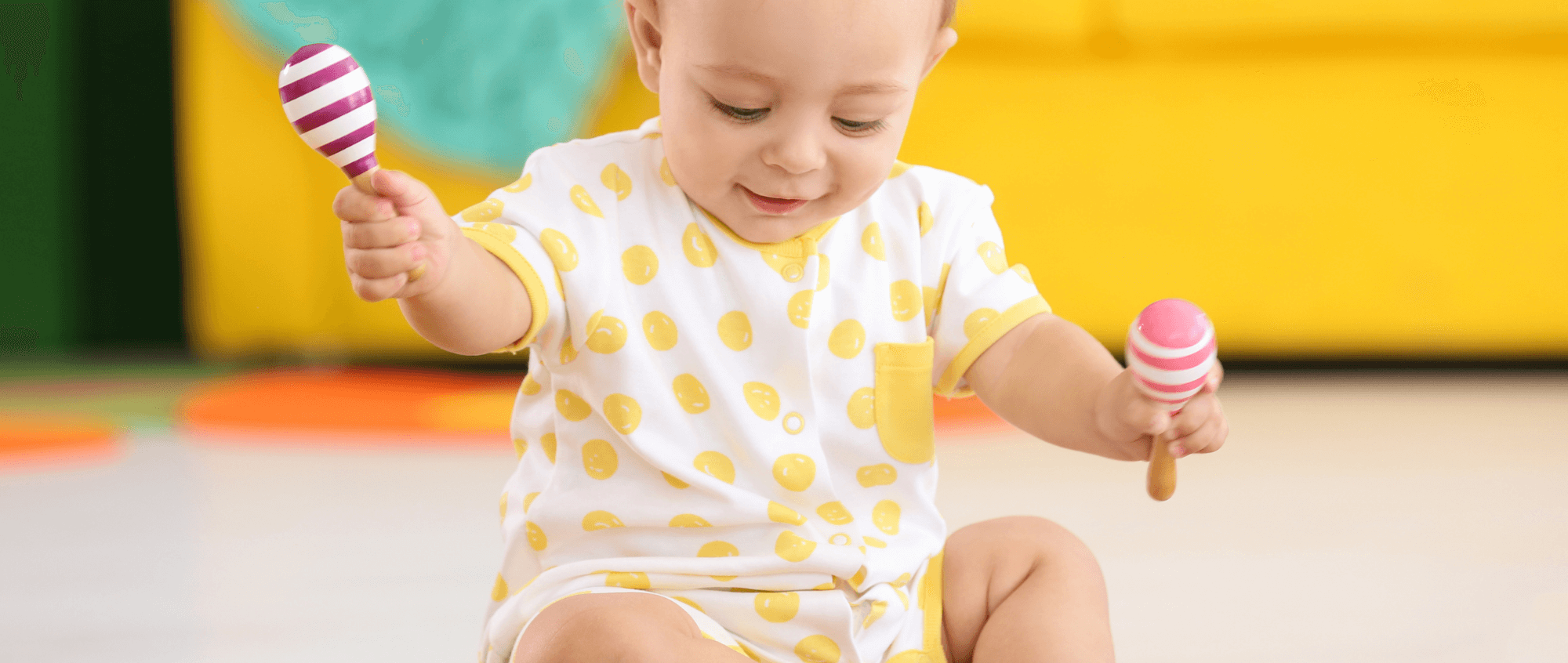 Baby playing with maracas
