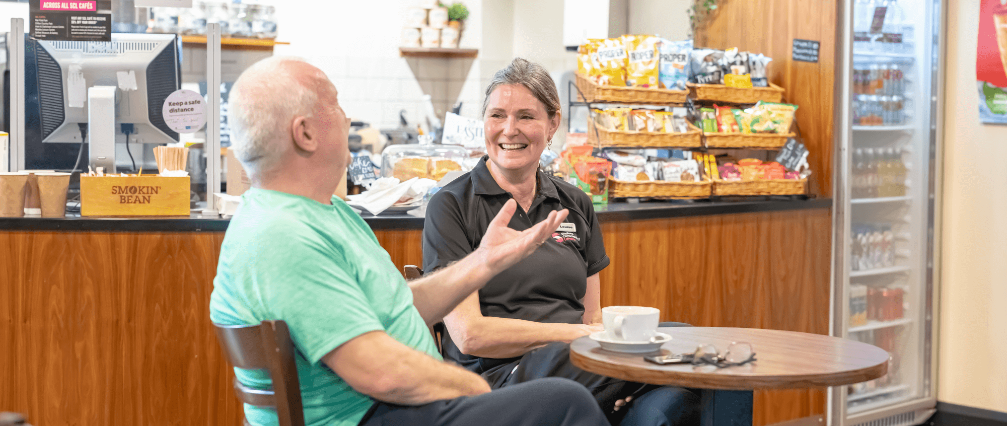 Member of staff speaking with a member