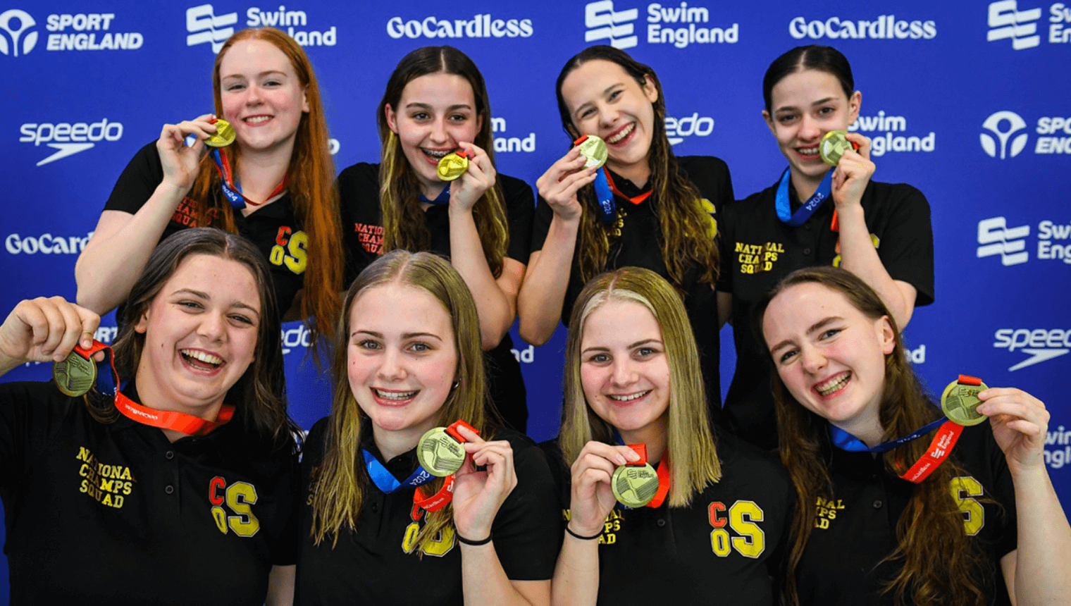 Girls holding medals