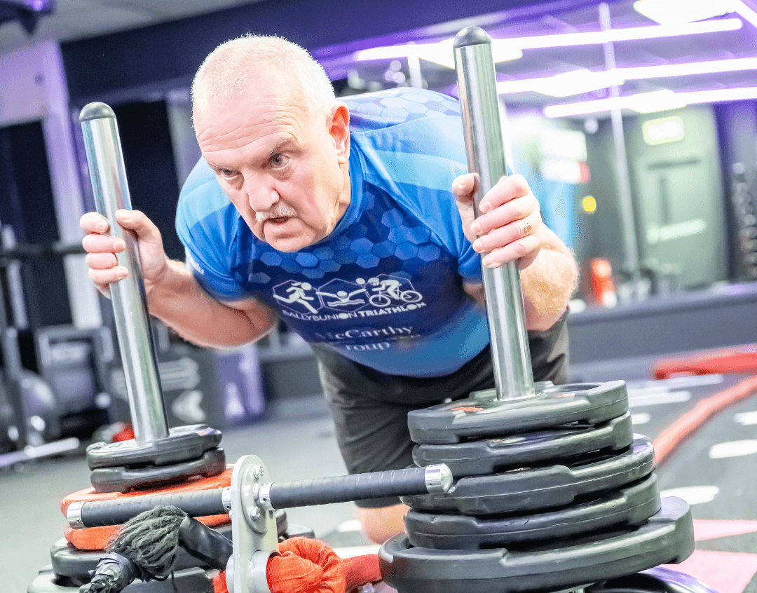 Gym member pushing a Sled track