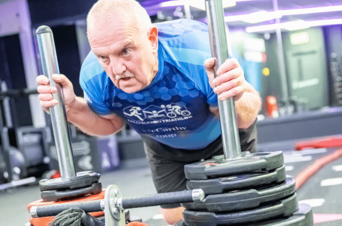 Gym member pushing a Sled track