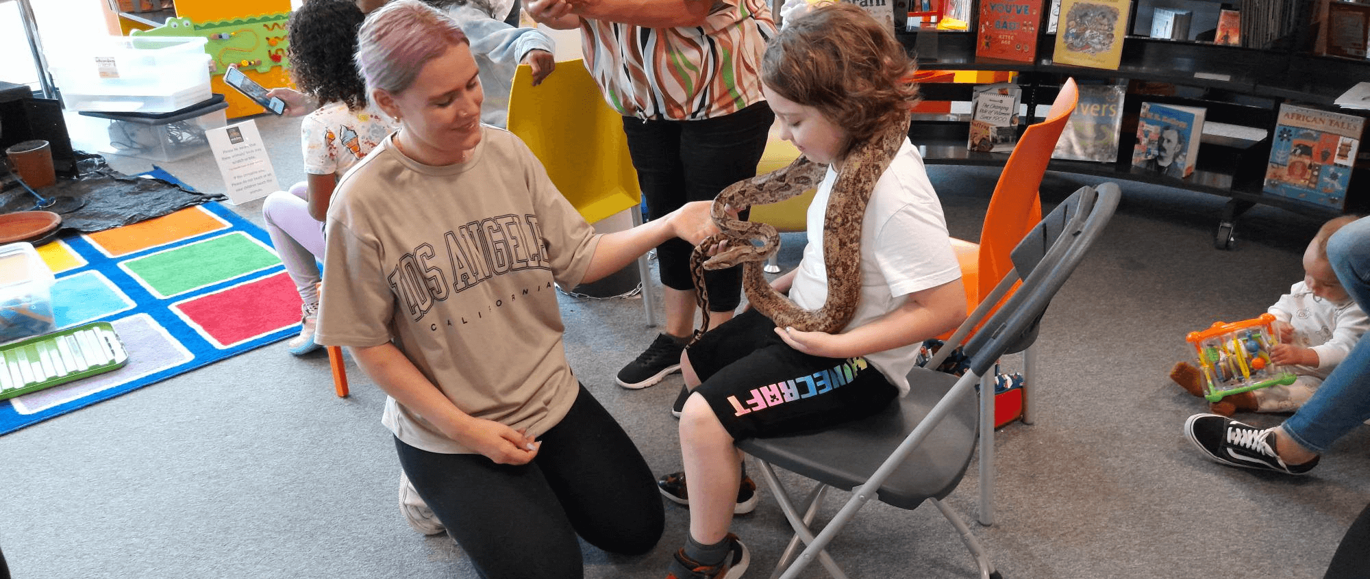 Child handling snake
