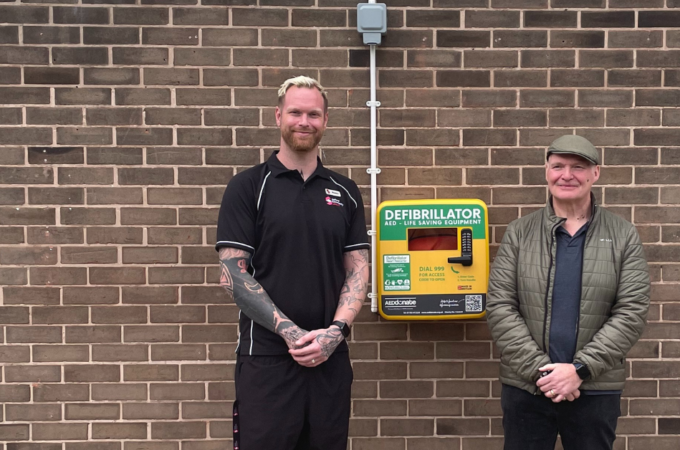 Benny Norris and Louis Lynch stood with the Irlam defibrillator