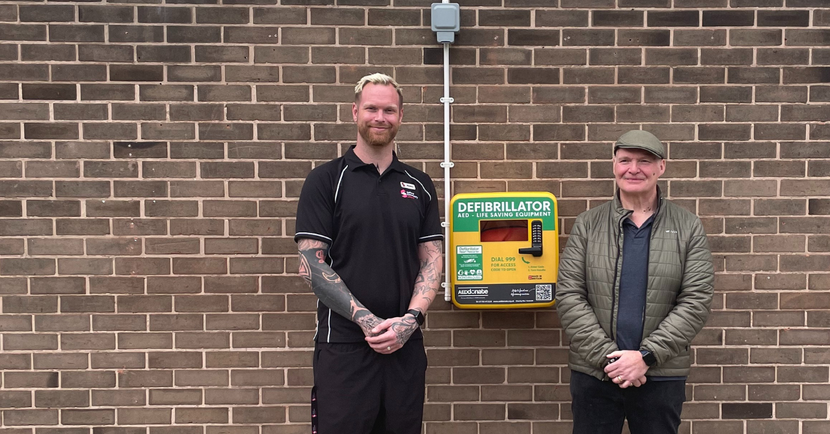 Benny Norris and Louis Lynch stood with the Irlam defibrillator