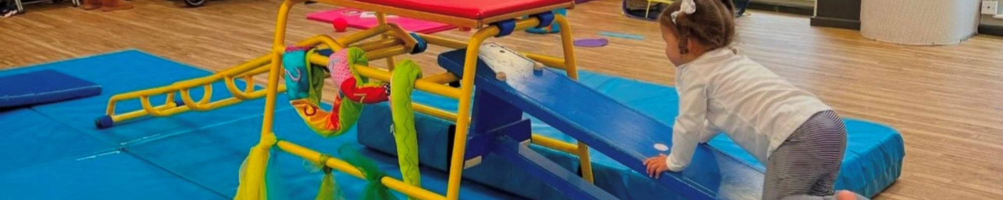 Young girl in baby gym class