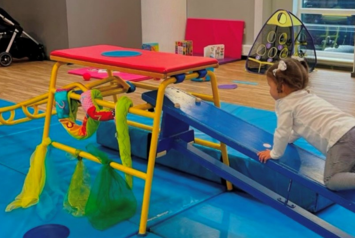 Young girl in baby gym class