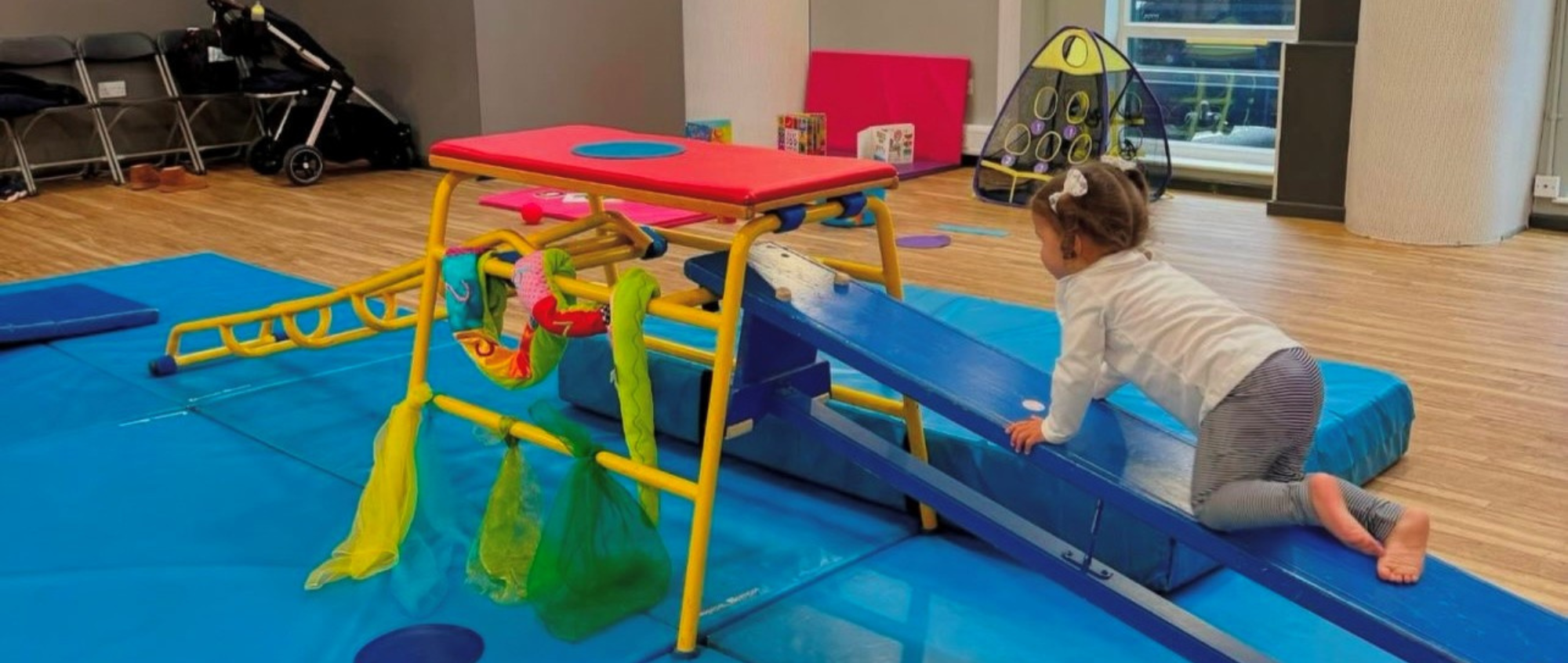 Young girl in baby gym class