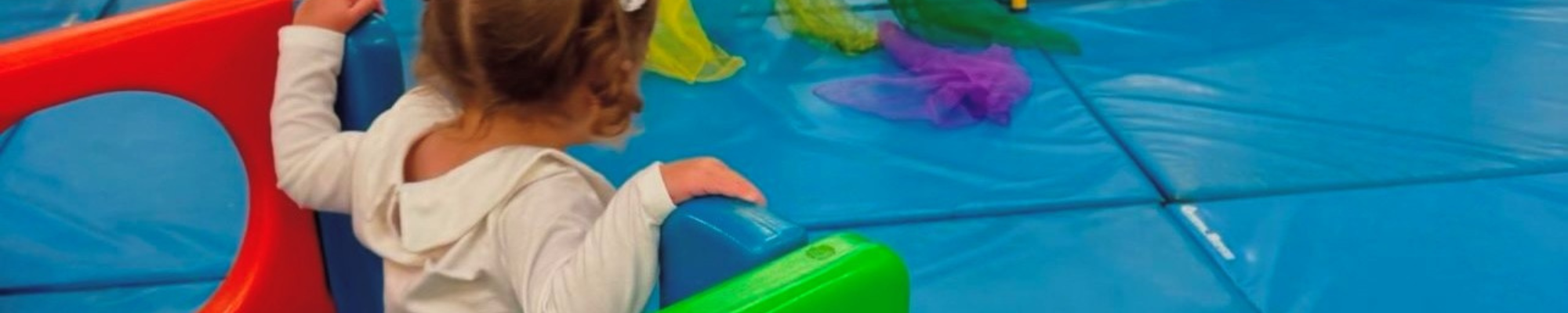 Young girl in baby gym class