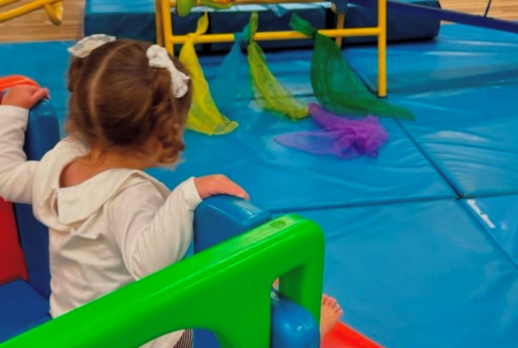 Young girl in baby gym class