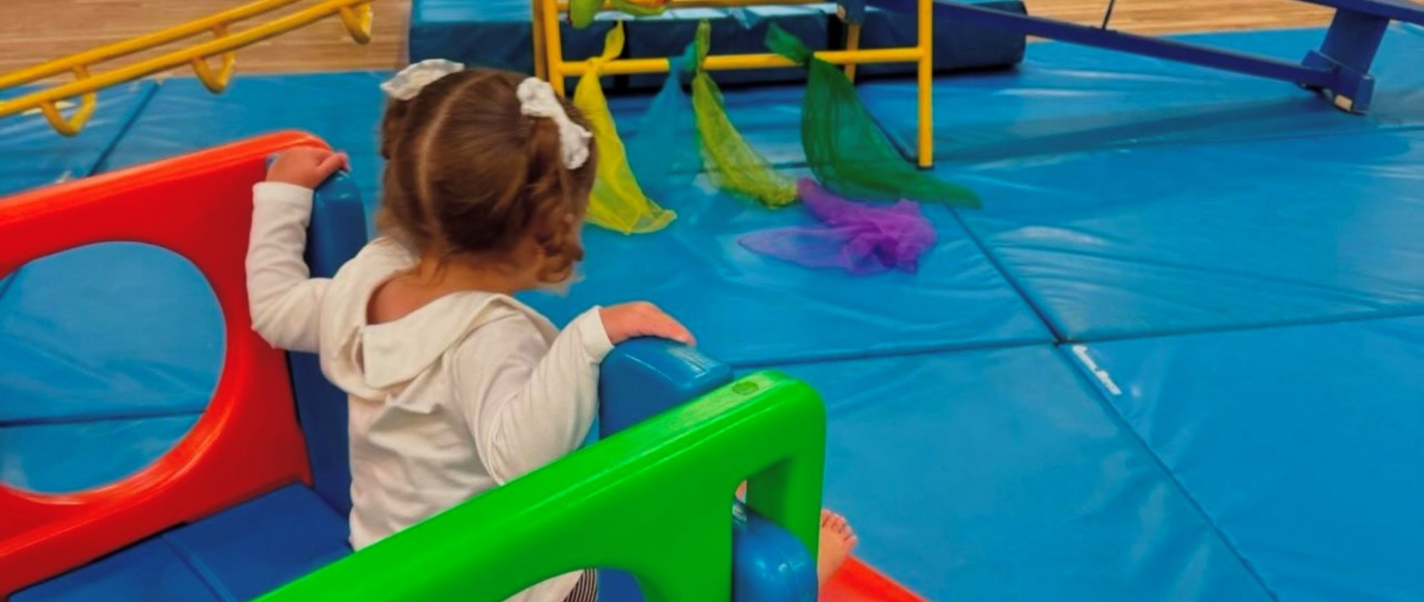 Young girl in baby gym class