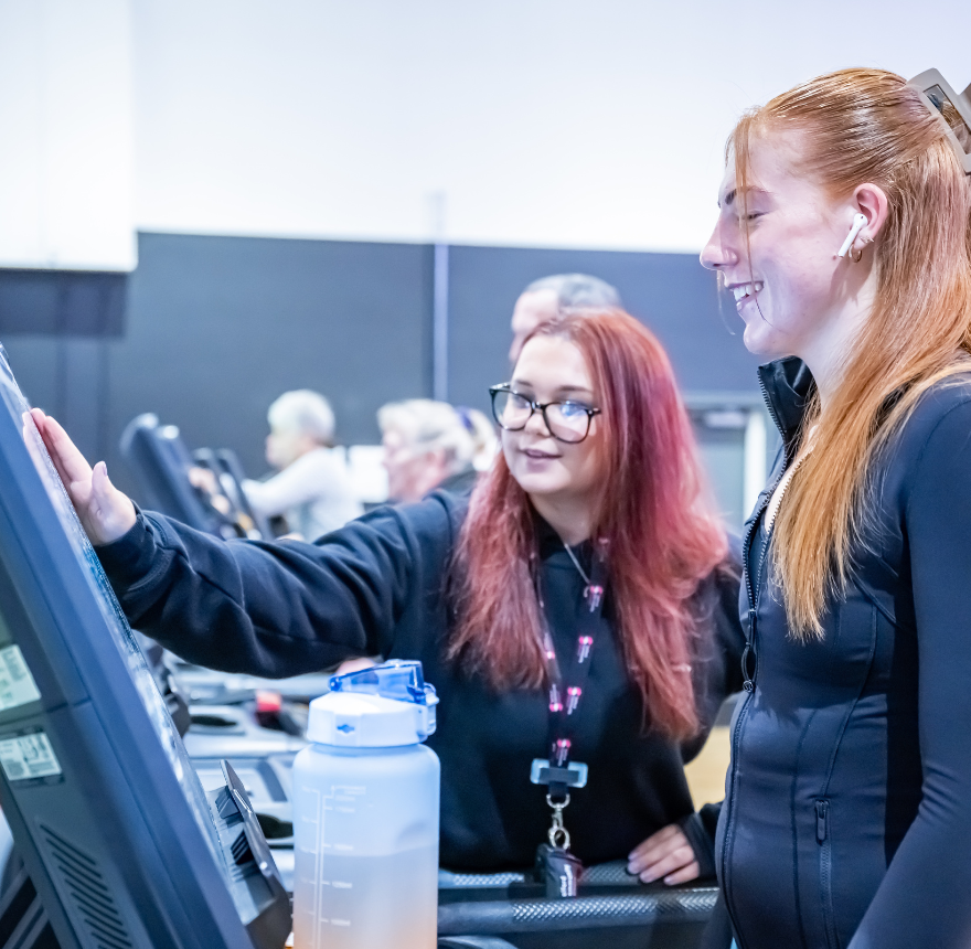 Woman showing a member on a treadmill