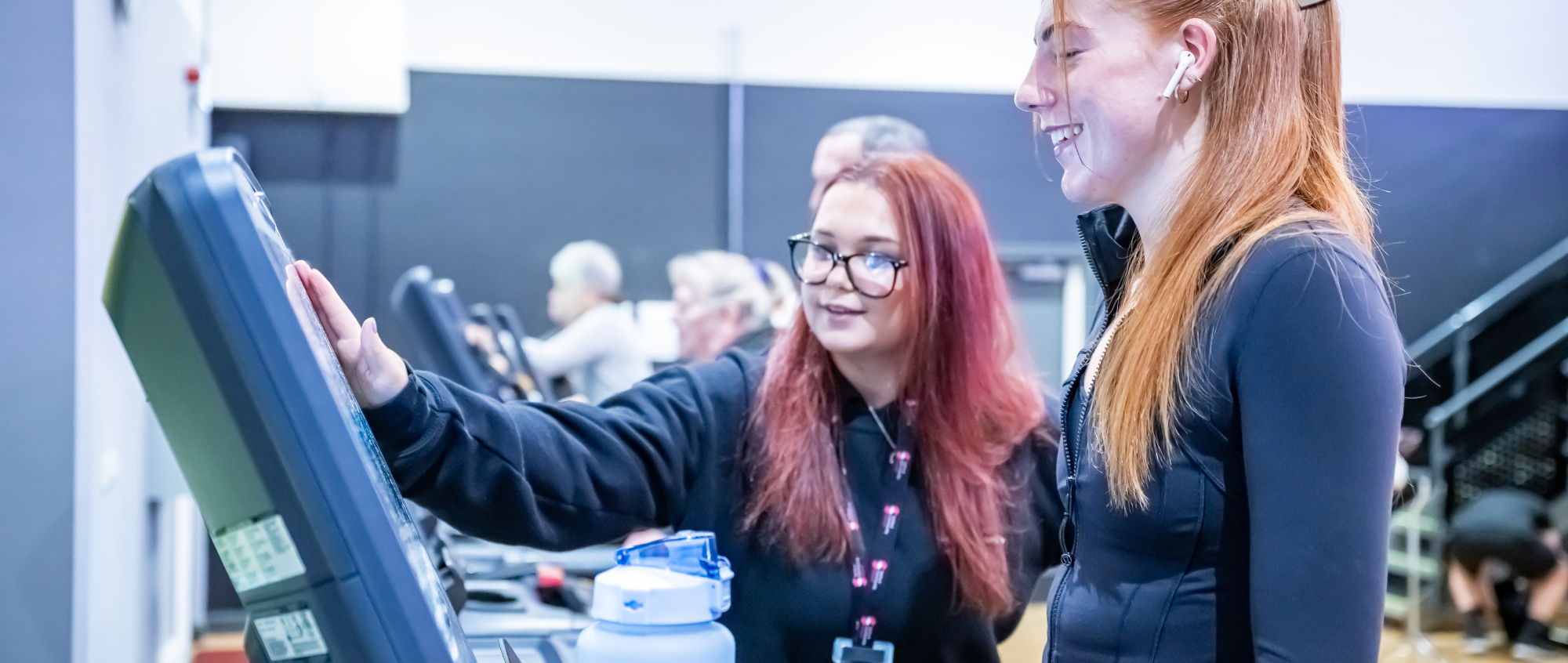 Woman showing a member on a treadmill