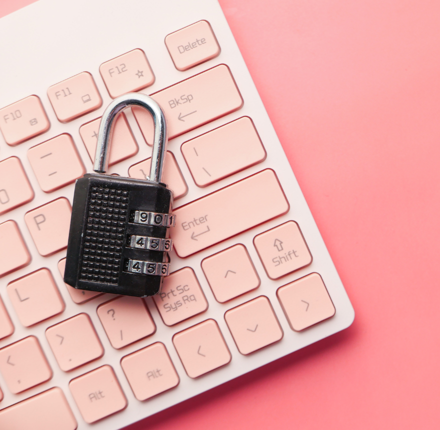 Pink keyboard with black padlock on a pink background