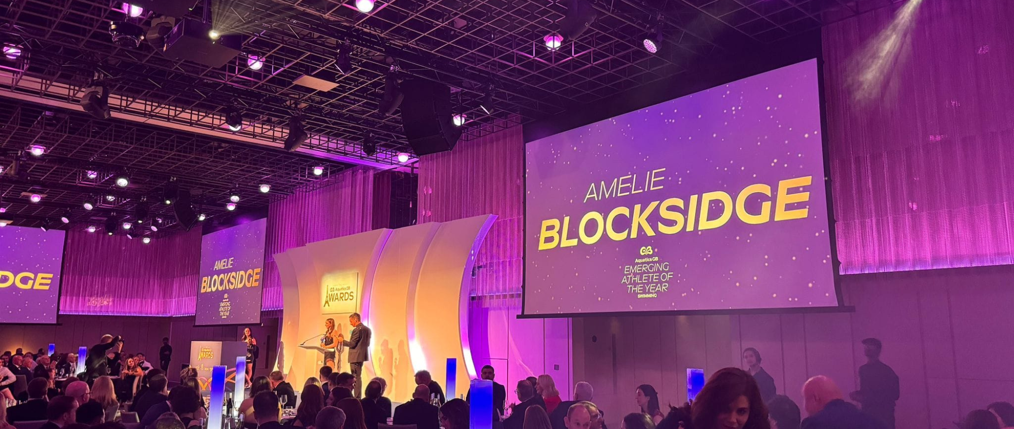 Amelie on a stage at awards