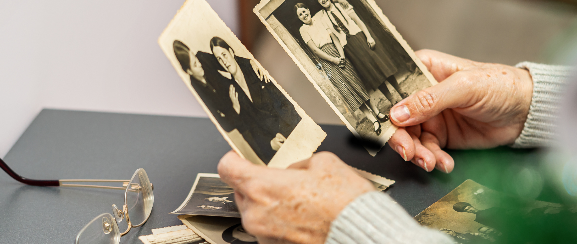 A photo of hands looking at old photos