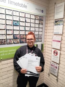 Girl standing holding certificates 