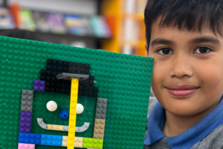 Young boy holding Lego