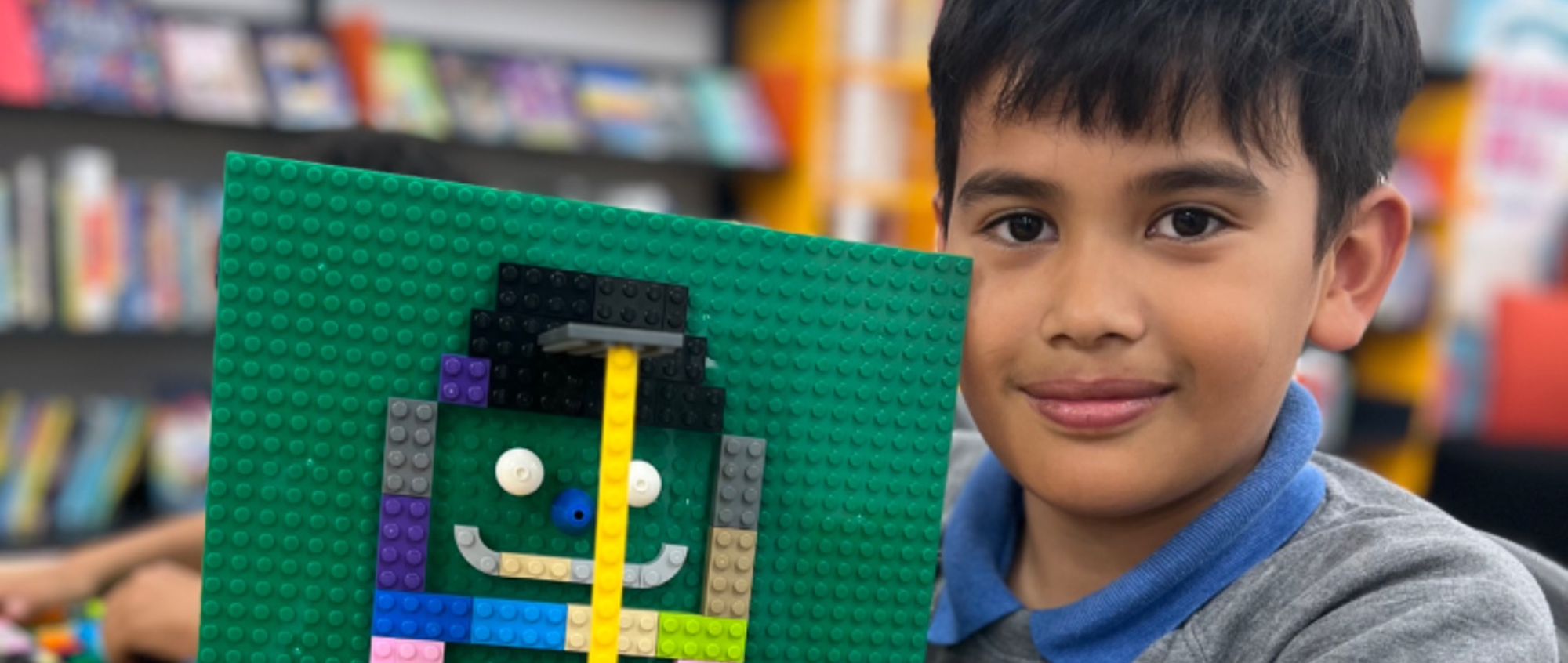 Young boy holding Lego