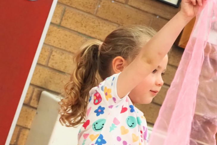 Girl holding a pink material