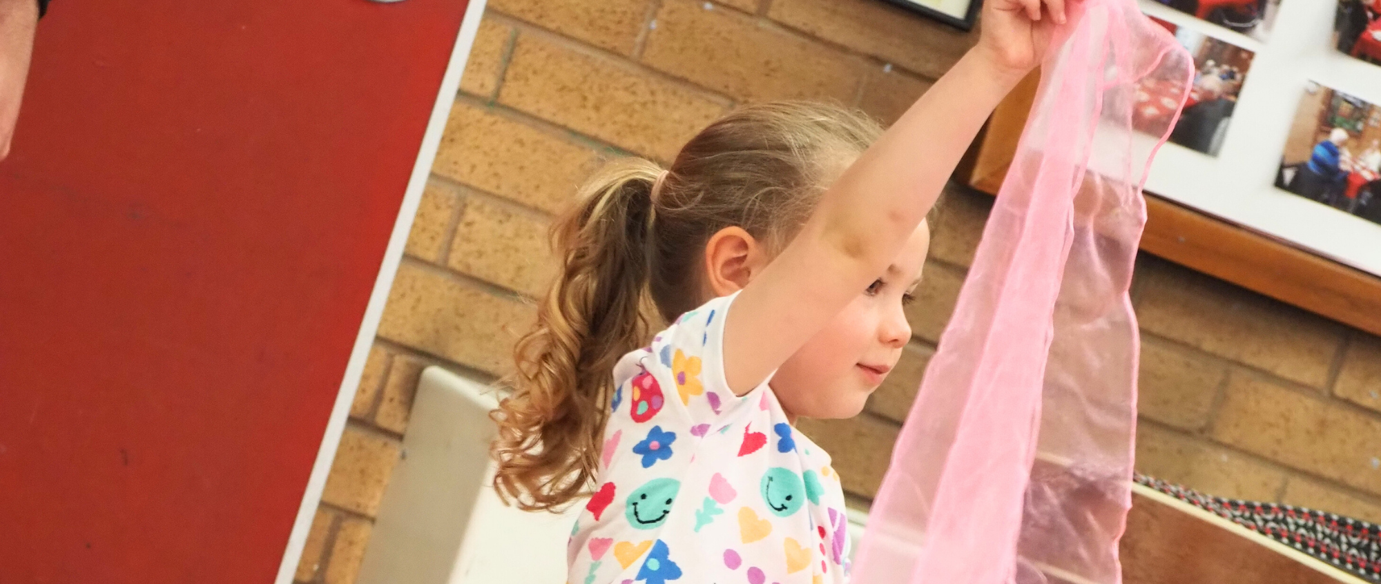 Girl holding a pink material