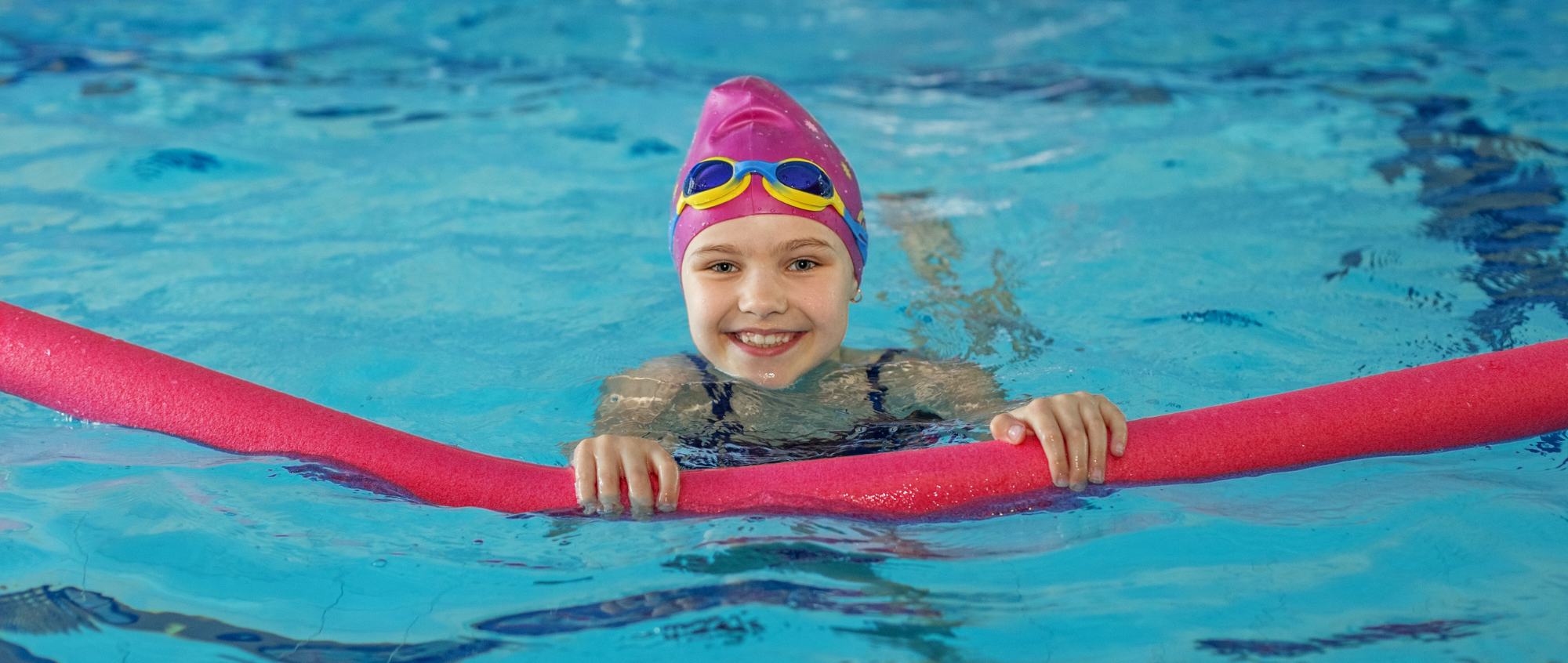 Girl with swimming cap in swimming pool