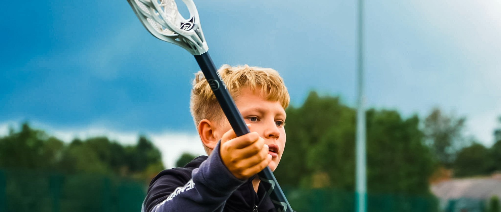 Young boy with racquet in hand