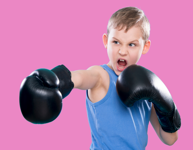 Young boy with boxing gloves on a pink background