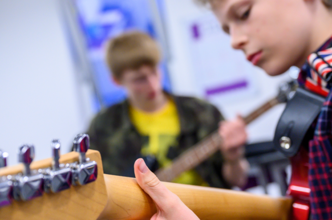 Young boys playing guitars