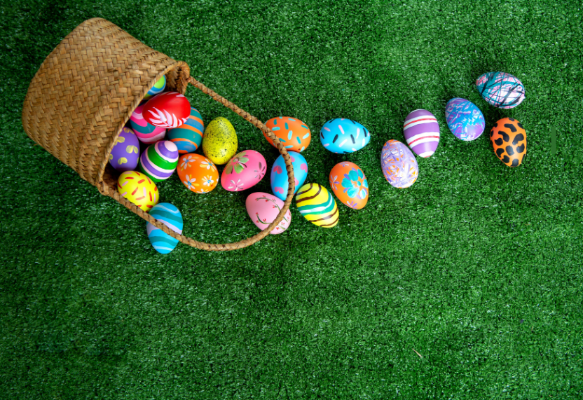Easter eggs and basket on grass
