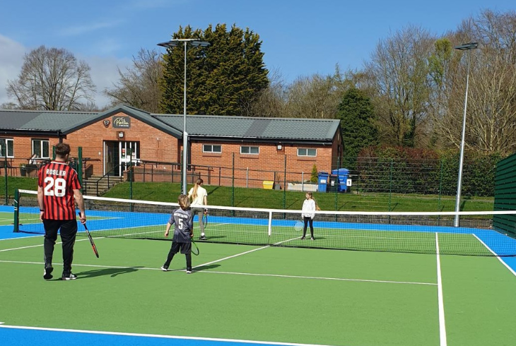 Family playing tennis at Parr Fold Park