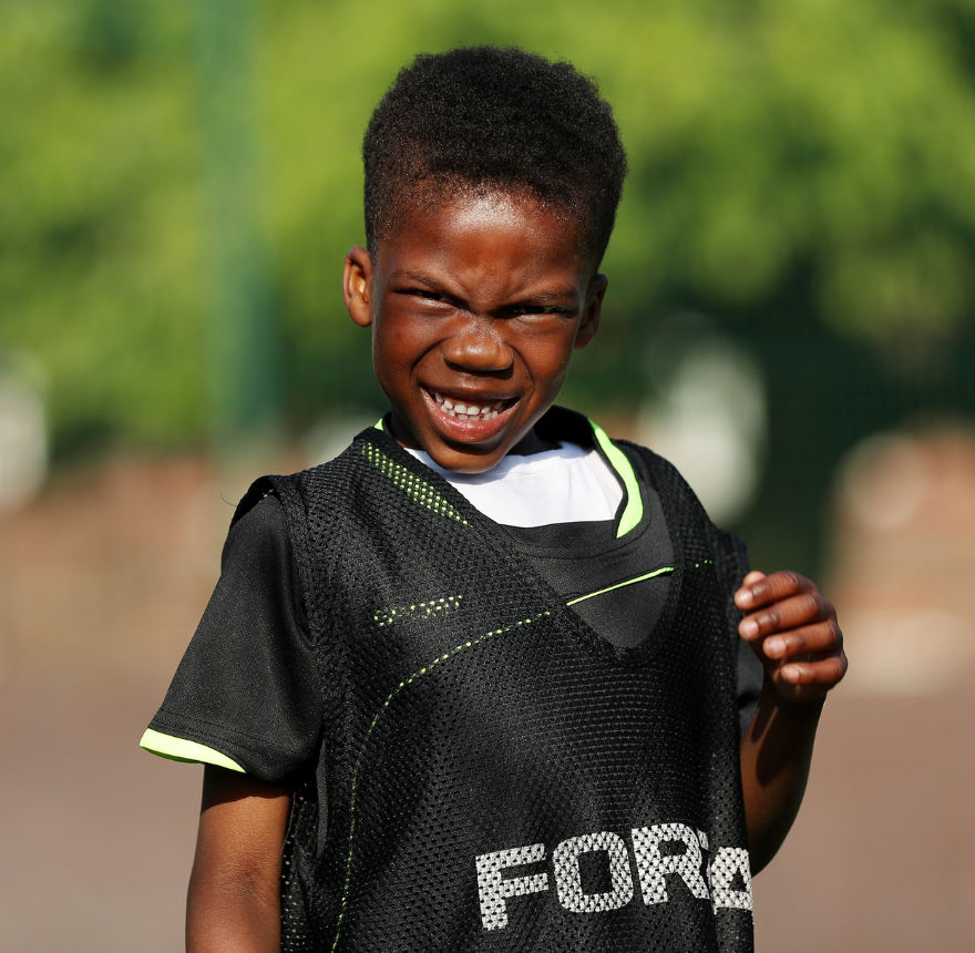 Boy holding a football bib