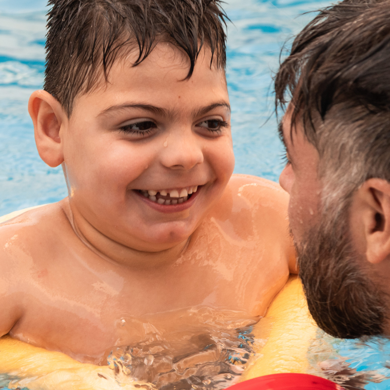 Child in pool with adult