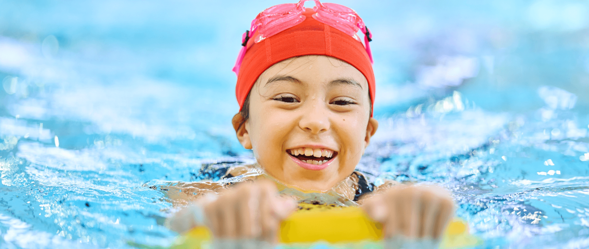 Child swimming in water with an aid