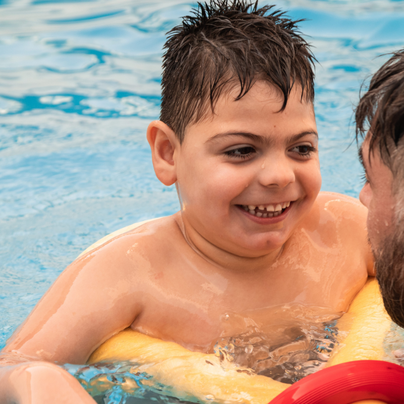 A boy in the pool, participating in the Starfish SEN swimming programme