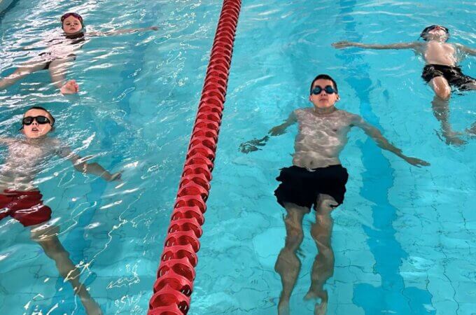 children from the Starfish swim programme in the water at Worsley Pool