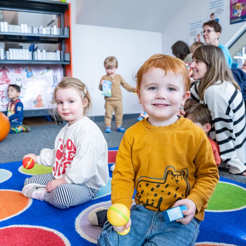 Children playing during Books & Rhymes session