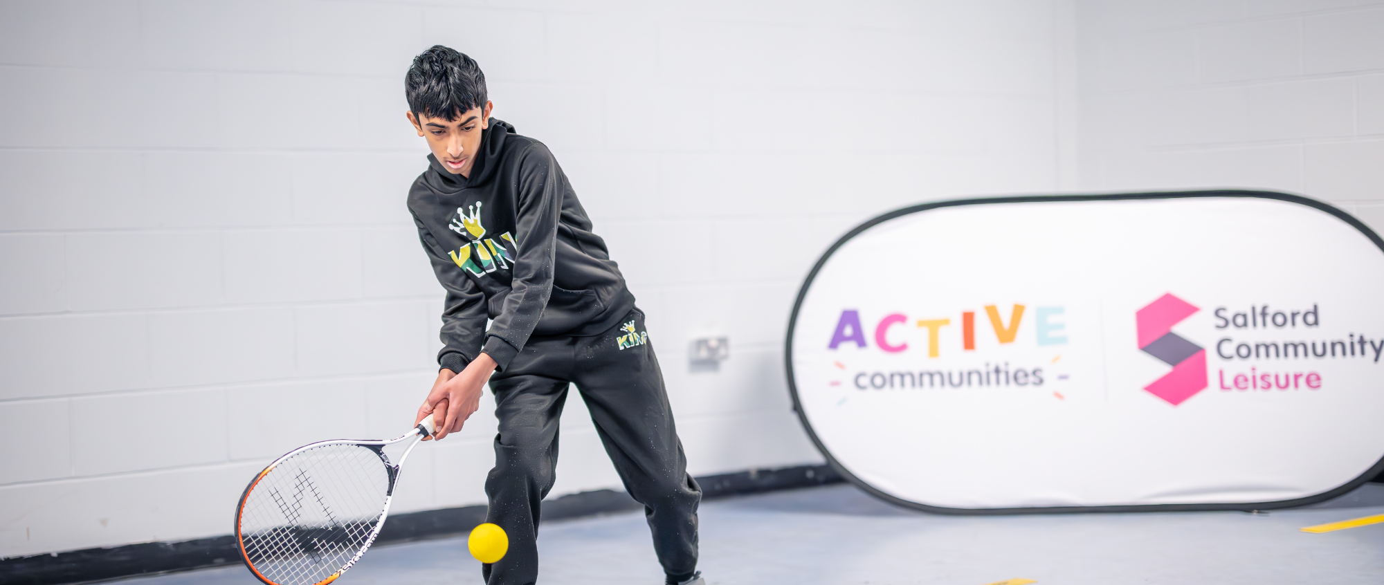 Young boy playing tennis
