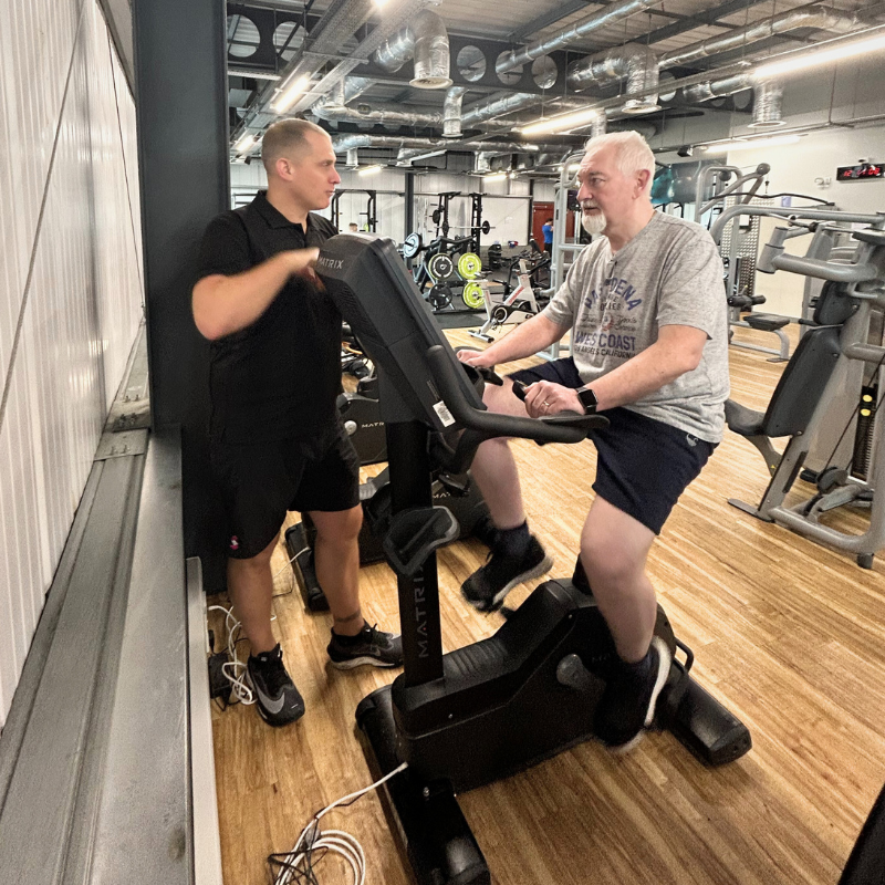 Kevin on a bike with Gareth coaching
