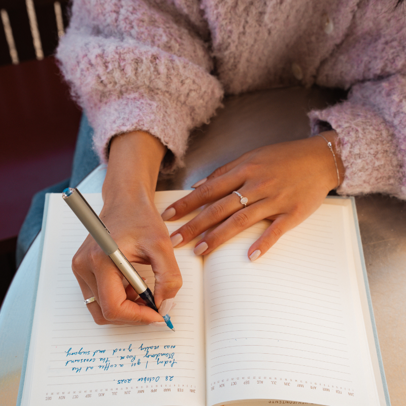 Person writing in notepad