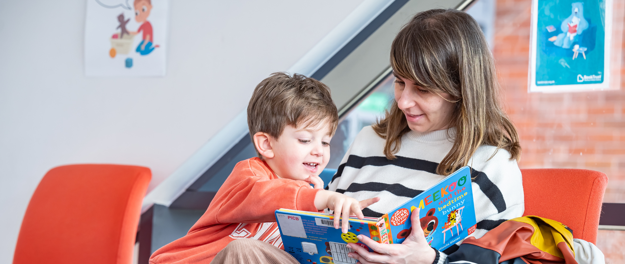 Woman holding a book with a child