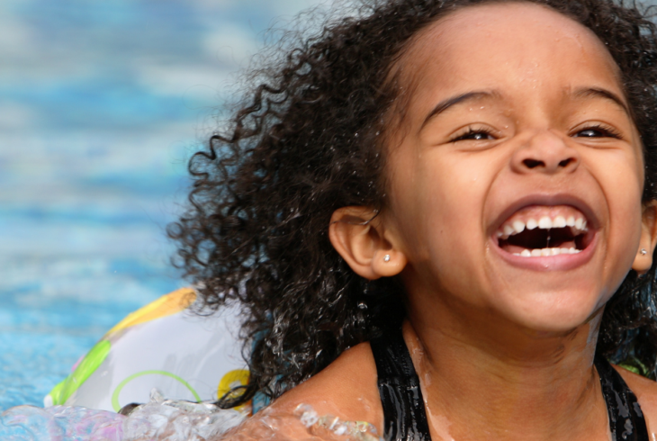 Girl smiling and having fun in a pool