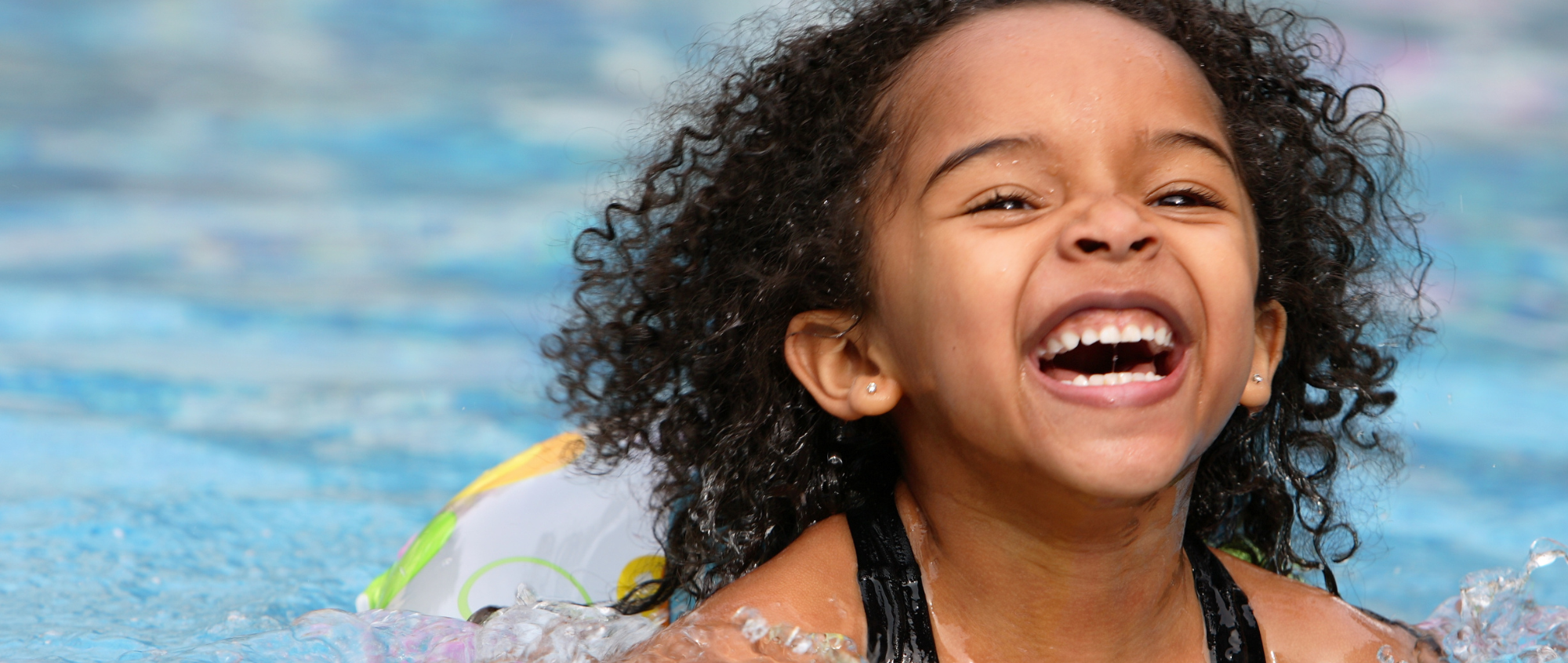 Girl smiling and having fun in a pool
