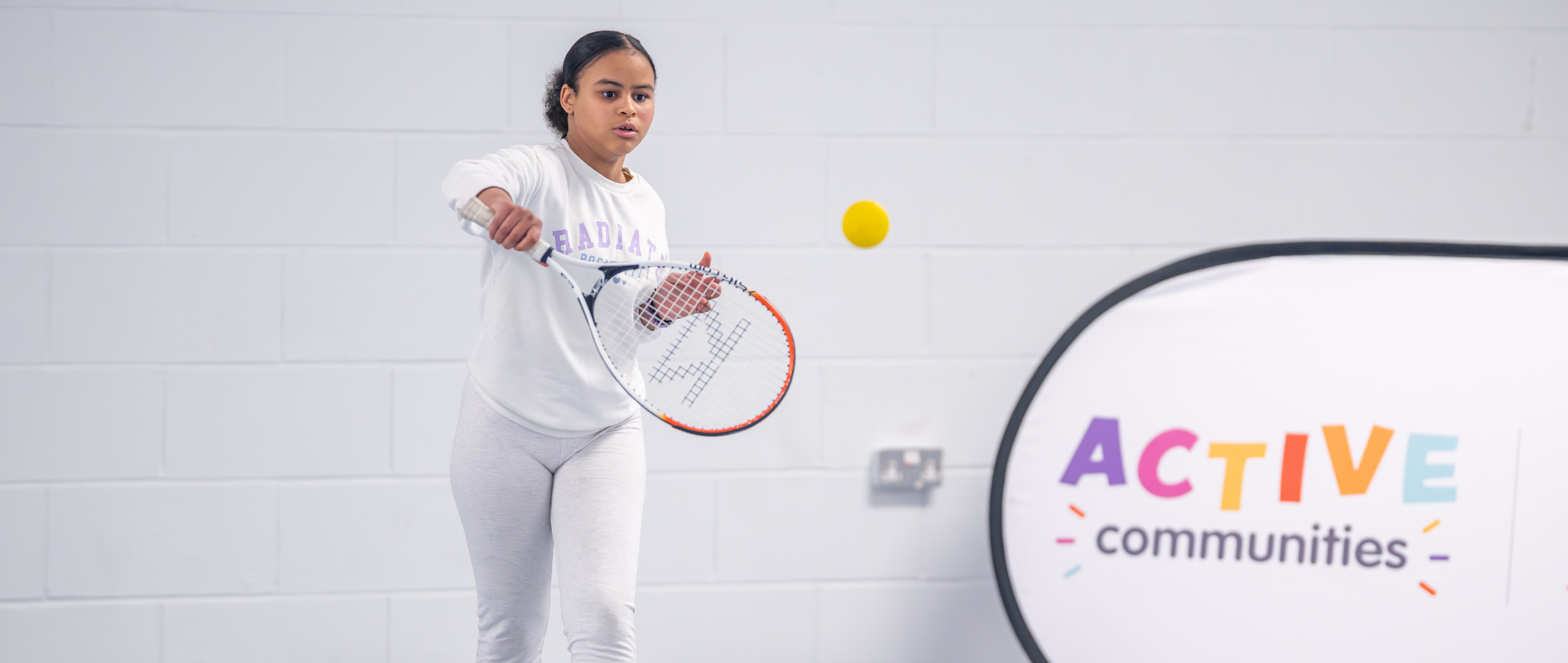 A girl playing tennis at SCL's new free tennis sessions