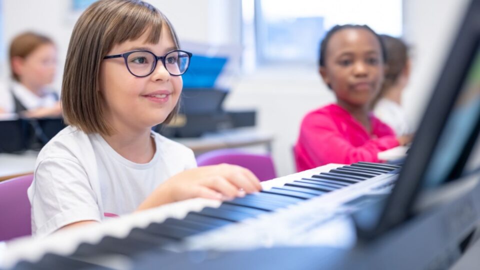 A class doing piano lesson