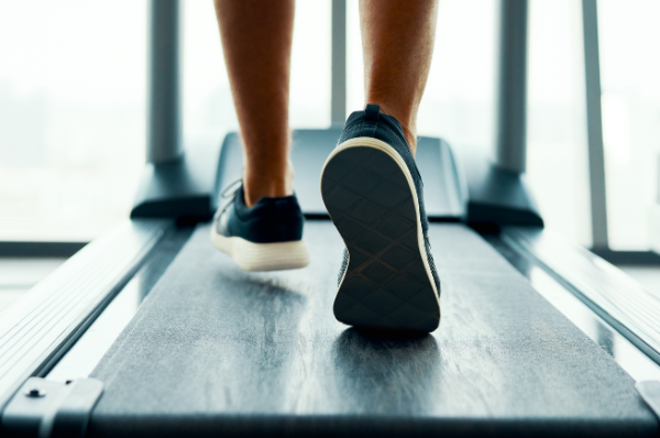 Feet walking on a treadmill