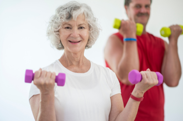 Lady and gentleman working out with small hand weights