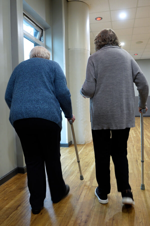 Ladies walking with walking stick inside a leisure centre