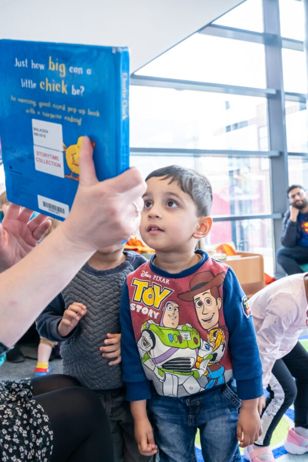 Children engaging with the storytime facilitator at Salford Libraries Books and Rhymes