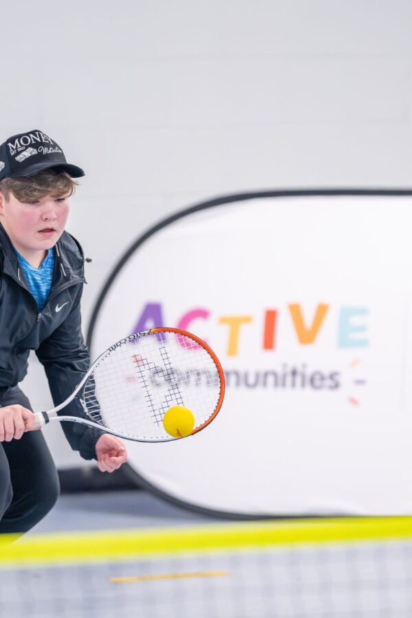 Free tennis programme: a boy plays tennis