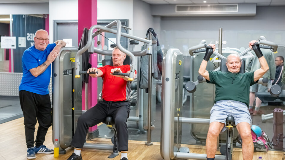 3 older gentleman taking part in older adult exercise in a SCL gym